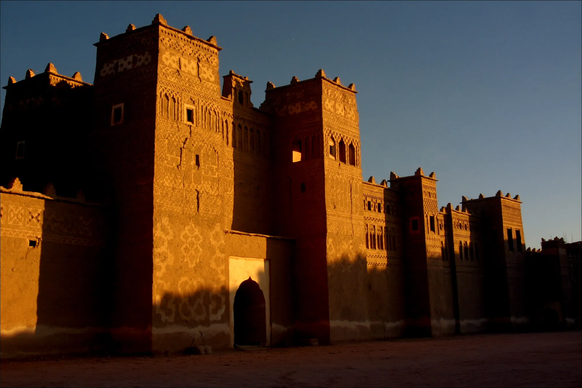 Golden evening light on the carved towers of Taourirt Kasbah